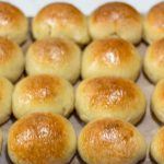 baked sourdough brioche rolls on baking sheets