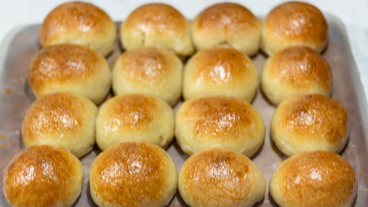 baked sourdough brioche rolls on baking sheets