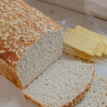 Sliced of Sourdough Honey oat Bread loaf with butter