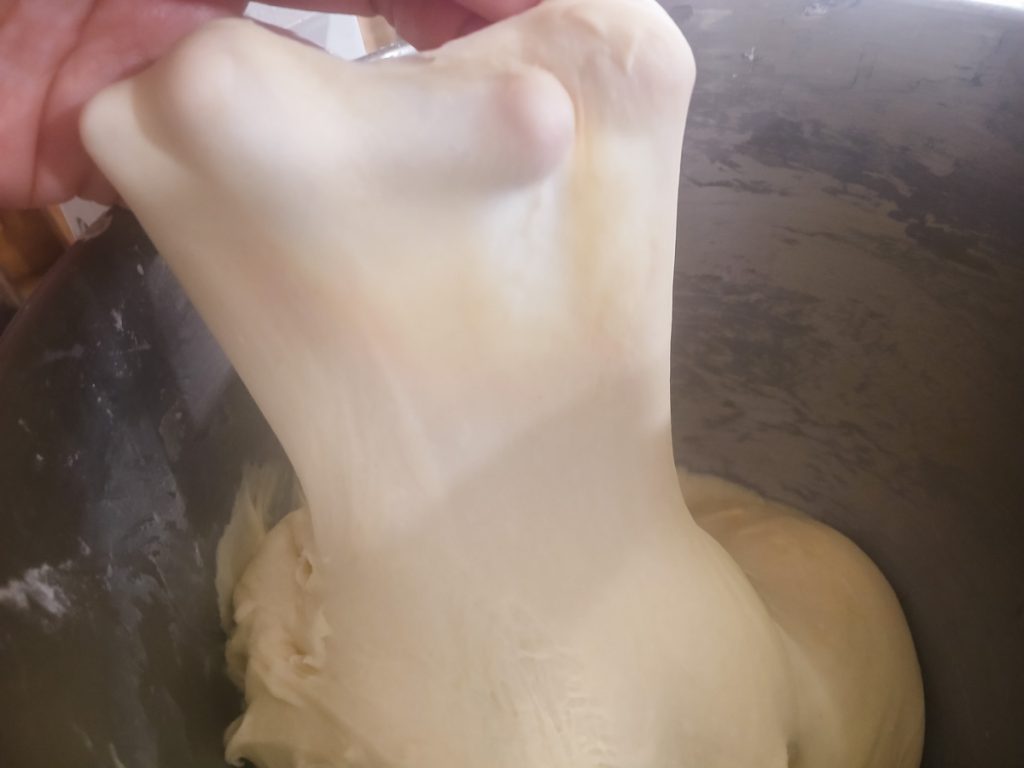 hand holding a wet dough