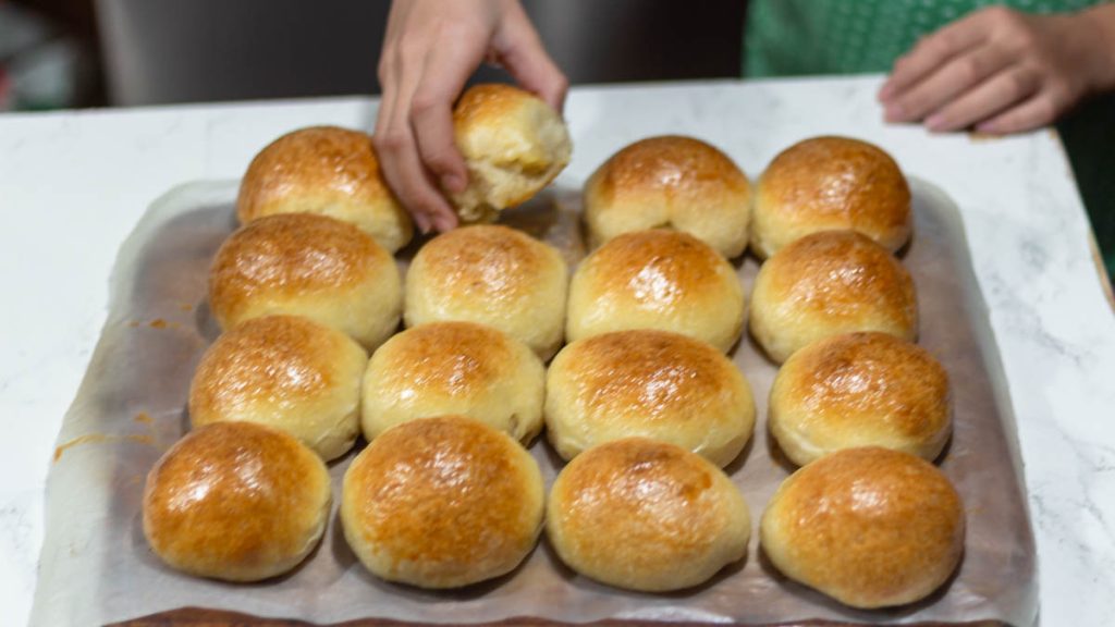 hand holding a sourdough brioche rolls