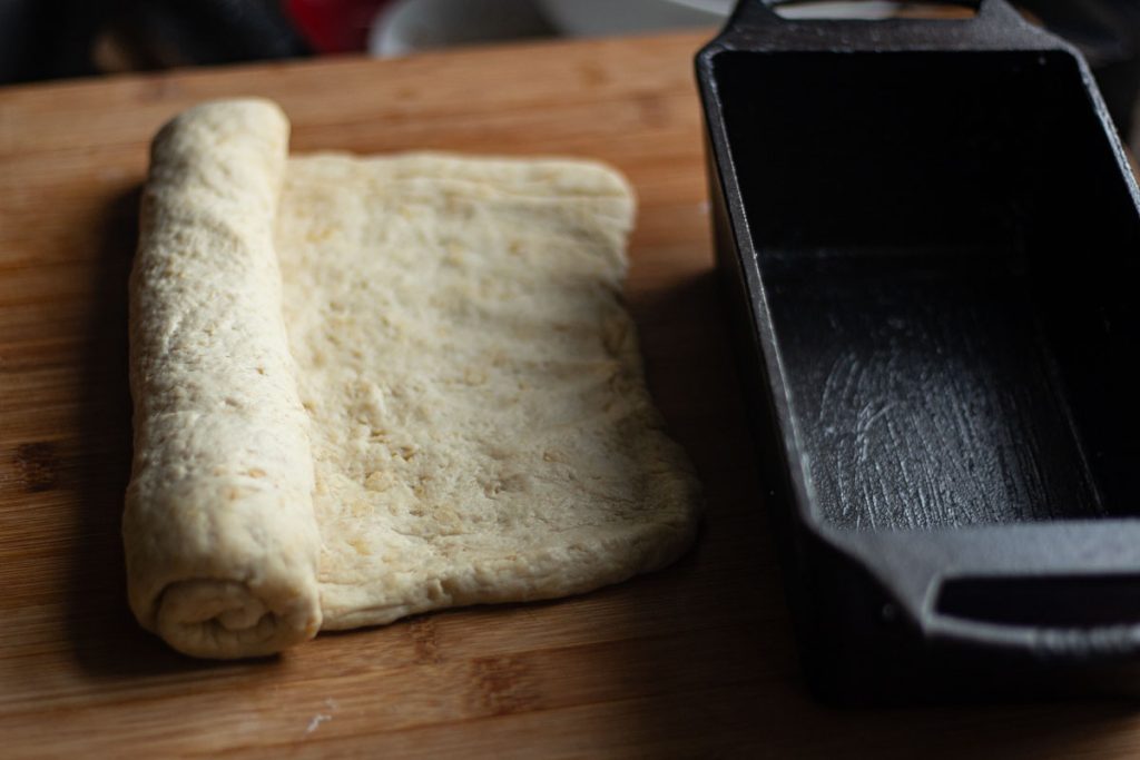 rolled dough in a log with cast iron loaf pan