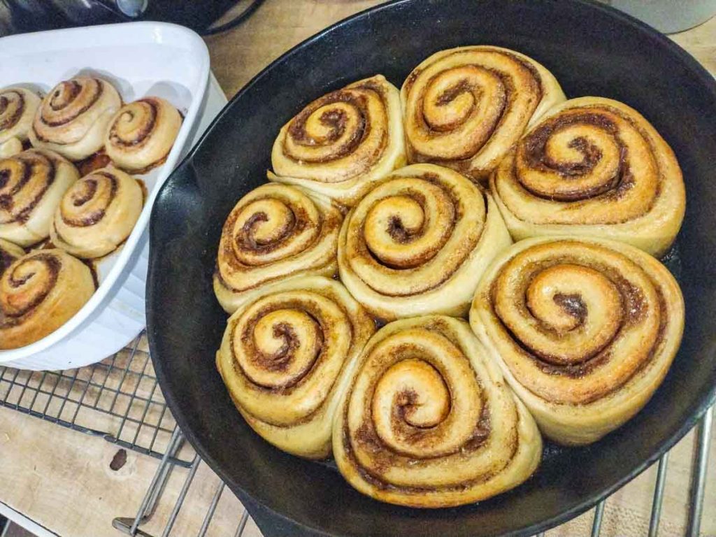 sourdough brioche cinnamon rolls in a cast iron pan