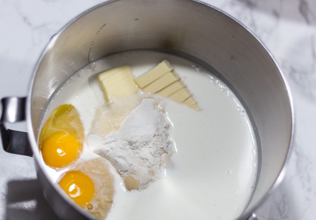 eggs, milk, butter, flour inside mixinbg bowl