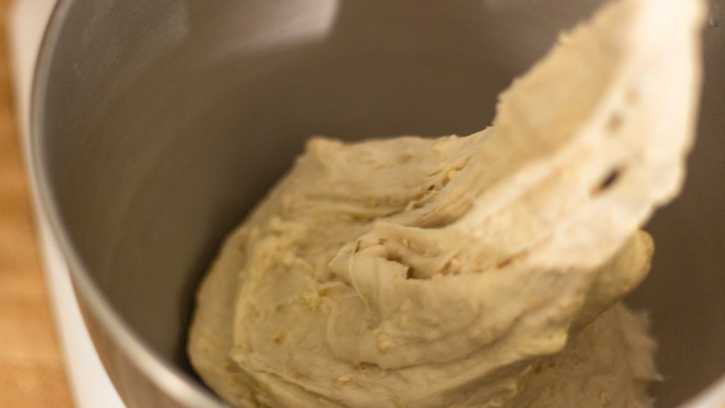 sourdough honey oat wet dough inside mixing bowl