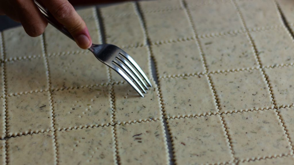 fork poking a hole on the dough