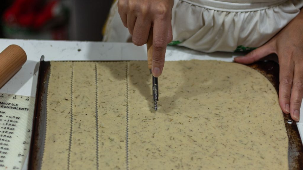 hand cutting sourdough crackers dough