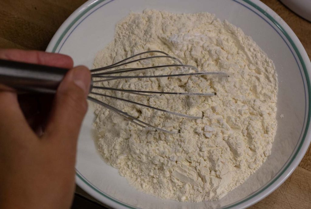 hand whisking sourdough cookies dry ingredients