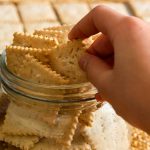 hand holding a sourdough crackers