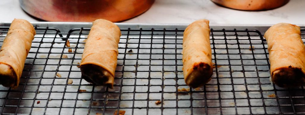 beef spring rolls on a cooling rack