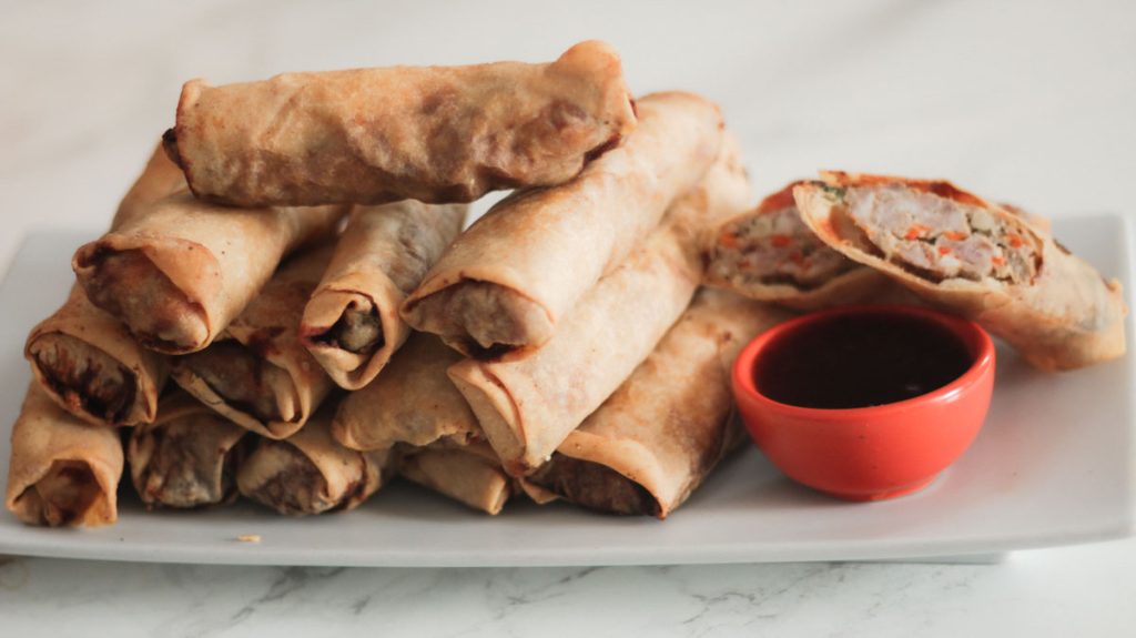 stack of spring rolls on a serving plate
