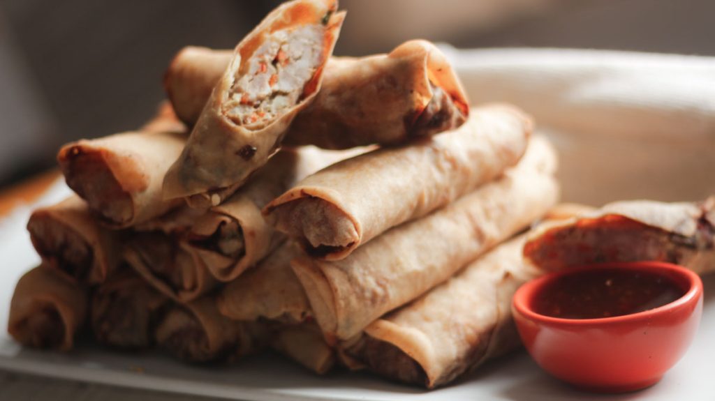 stacked beef spring rolls on a serving plate
