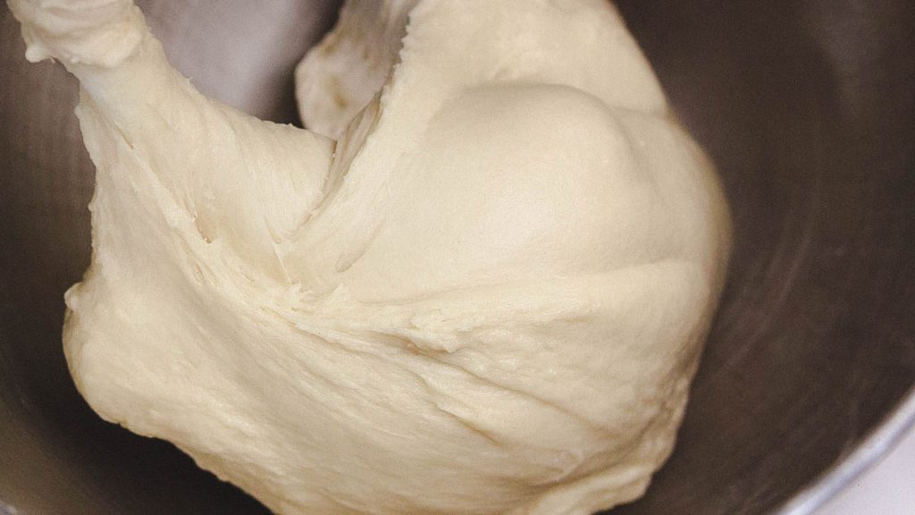 wet dough inside mixing bowl